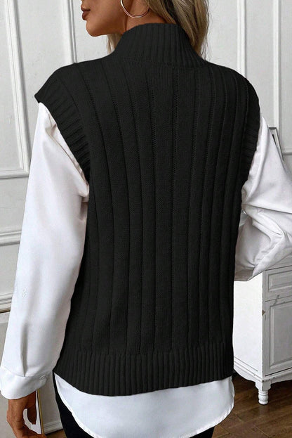 Cable-knit mock neck sweater vest in black, highly stretchy, made of 100% acrylic.