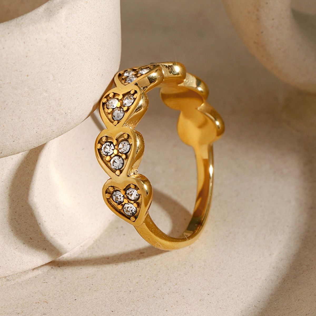 18K gold-plated stainless steel ring with zircon heart inlays.