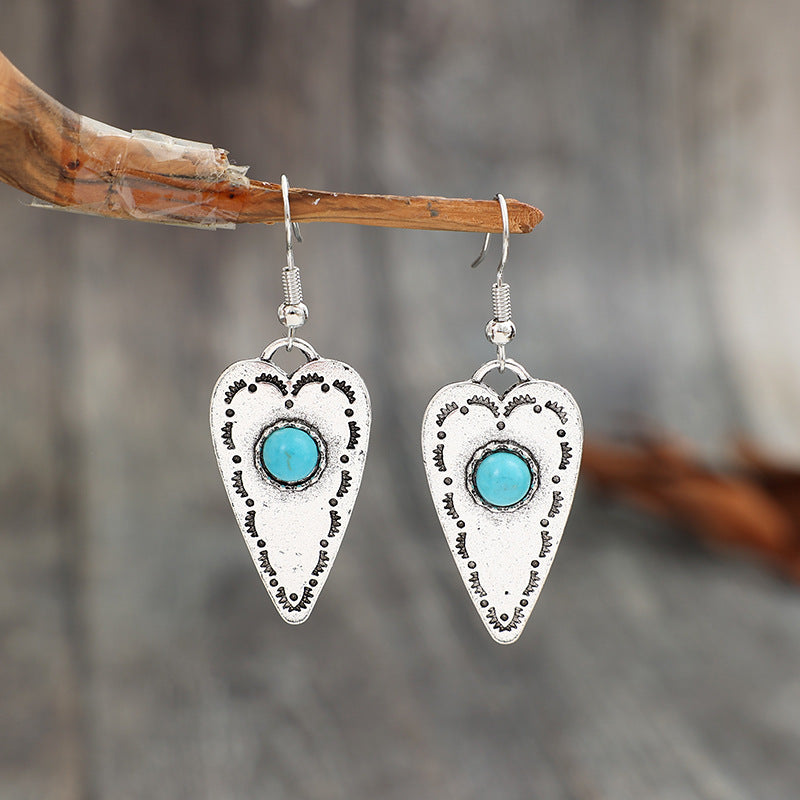 Turquoise heart dangle earrings with silver-plated alloy design.