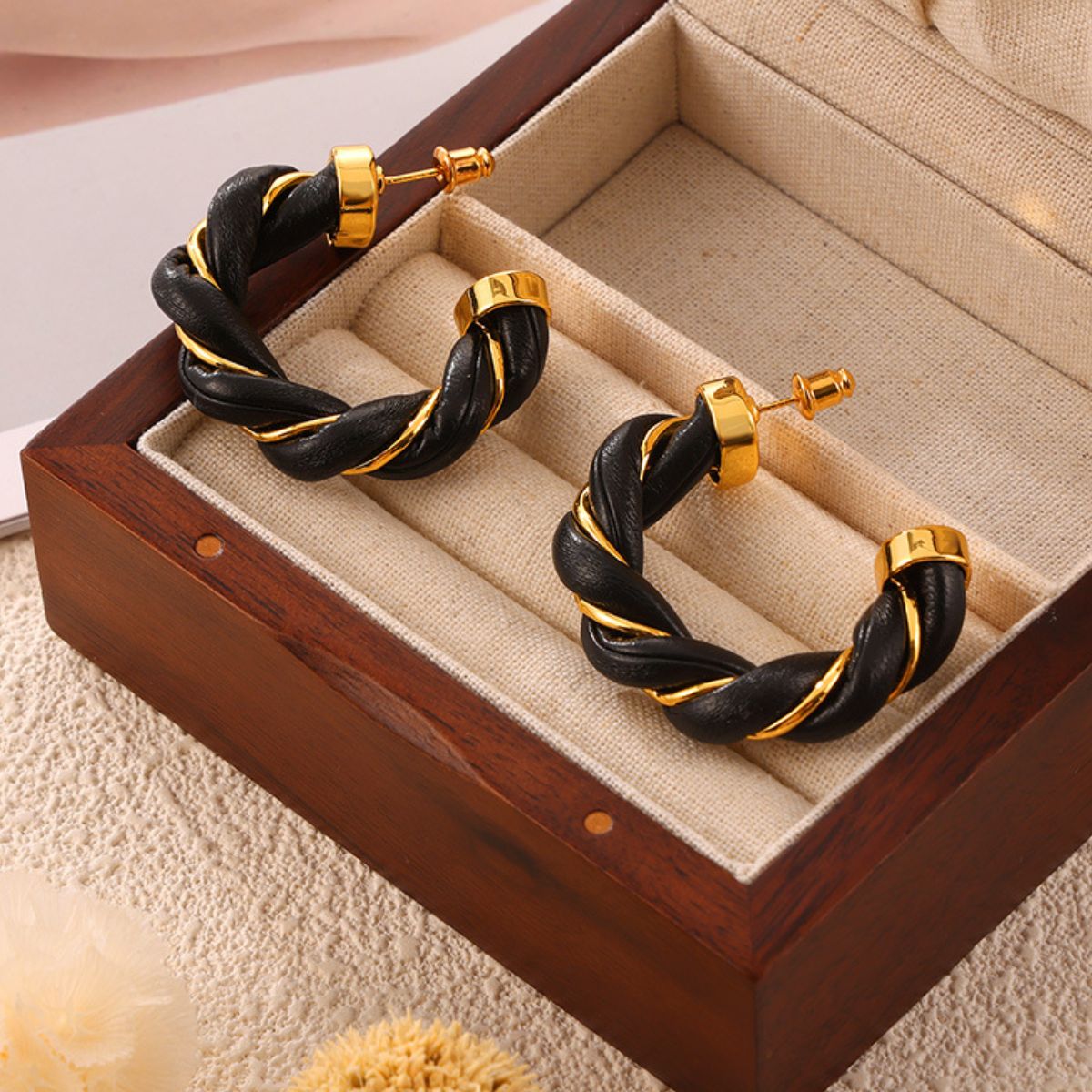 18K gold-plated twisted leather rope C-hoop earrings in a wooden box.