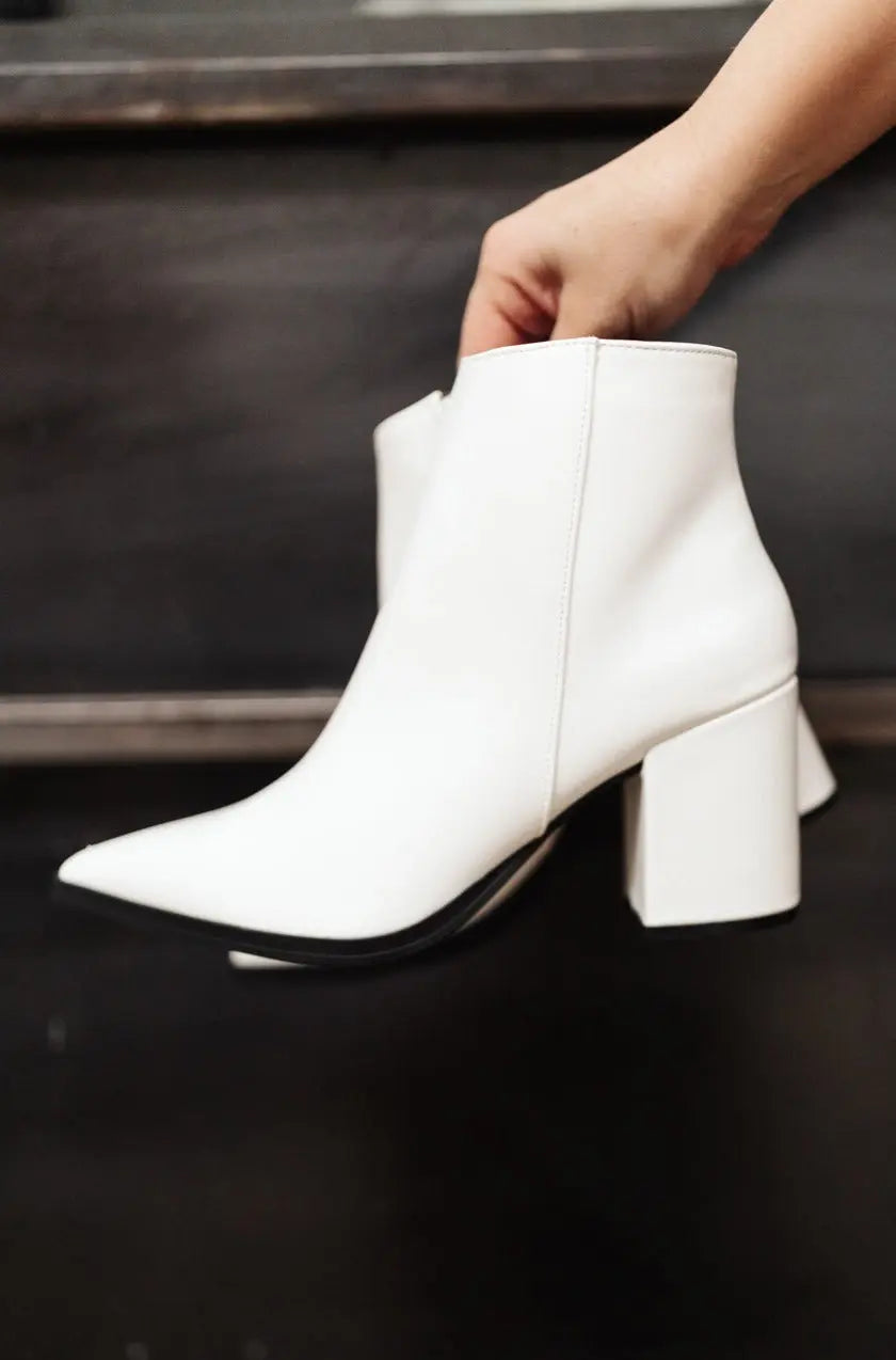 White Amari Ankle Boots with pointed toe and faux leather finish.