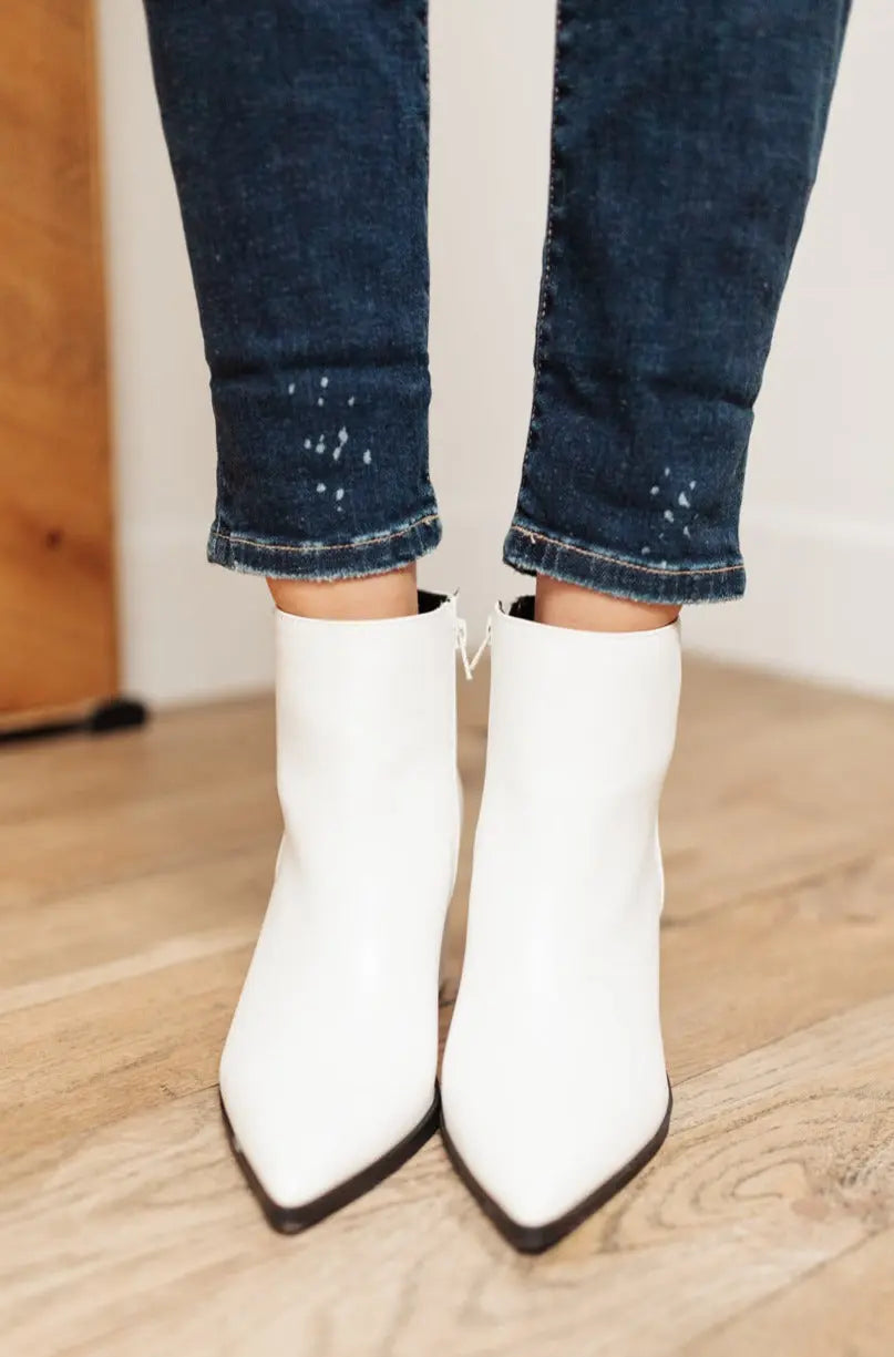 White faux leather Amari Ankle Boots with pointed toes and 2.5-inch heels.