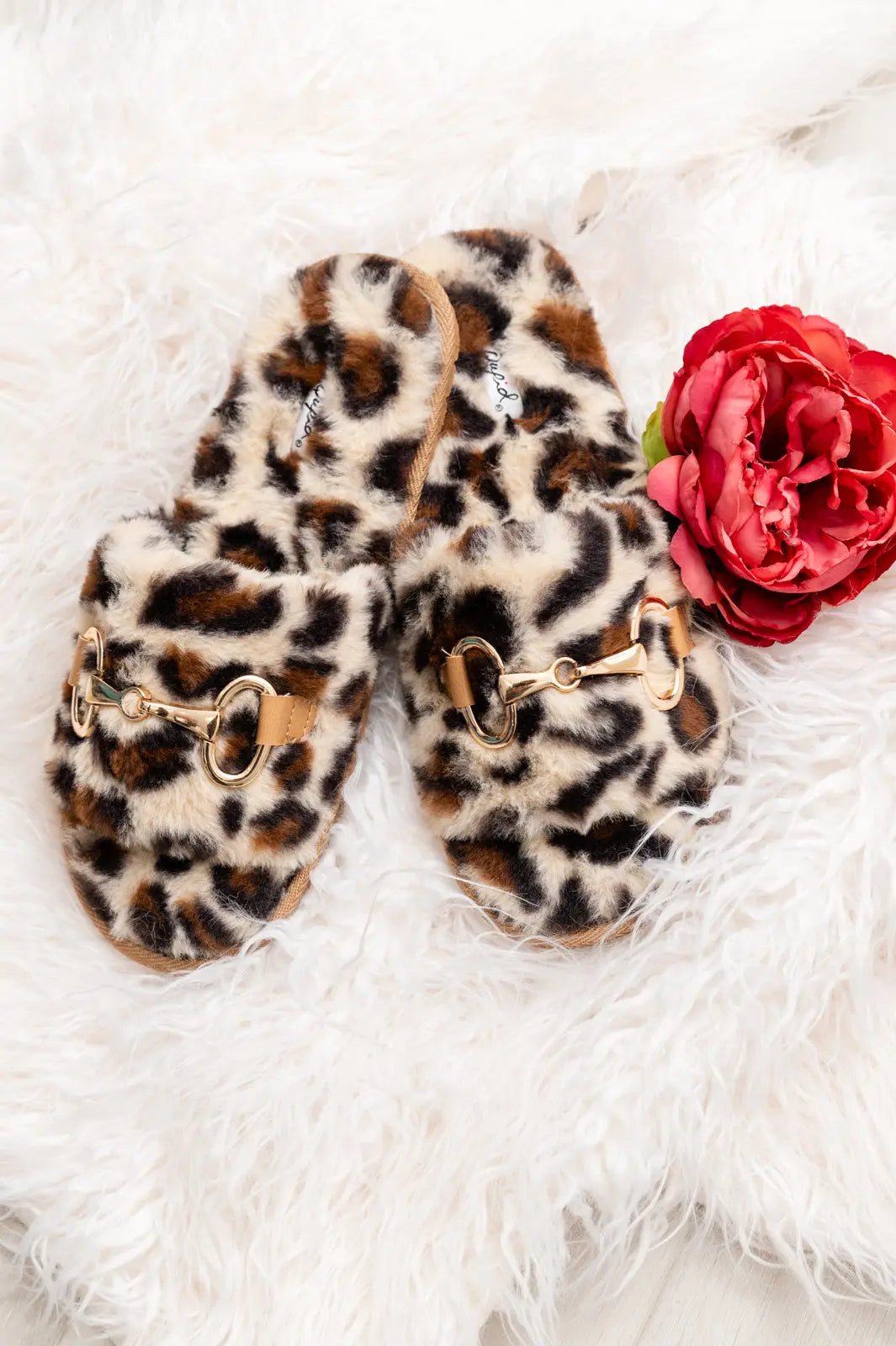 Cozy animal print slippers with faux fur and horse bit metal detail.