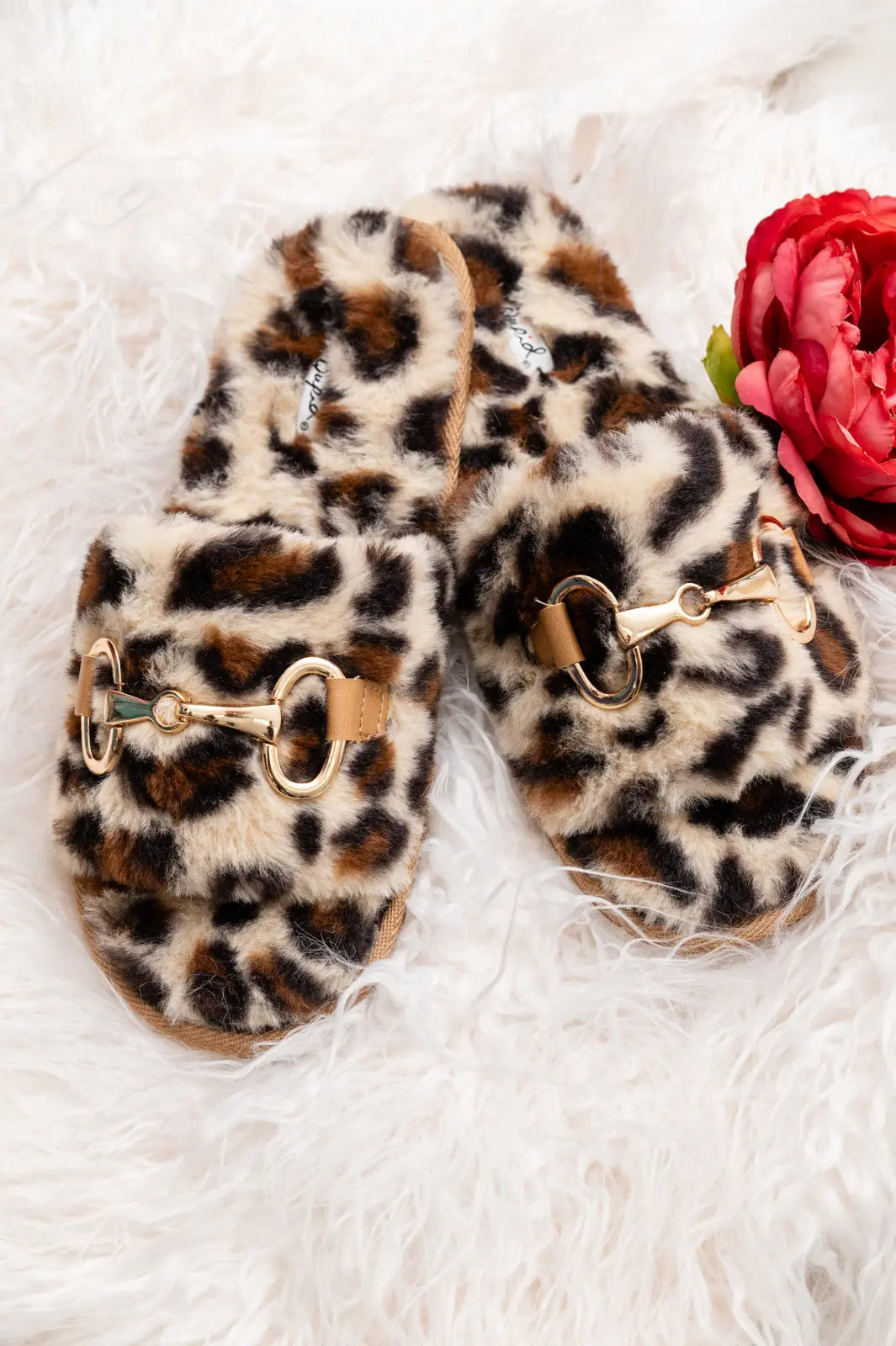 Cozy animal print slippers with faux fur and horse bit detail.