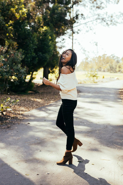 Woman wearing Malibu Boots Brown outdoors on a sunny path.