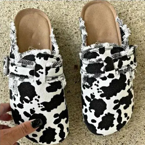 Flat heel round toe canvas loafer women's vintage clogs with cow print design.