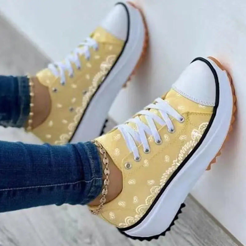 2024 pattern canvas women sneakers casual sport shoes, yellow design, displayed on person leaning against wall.