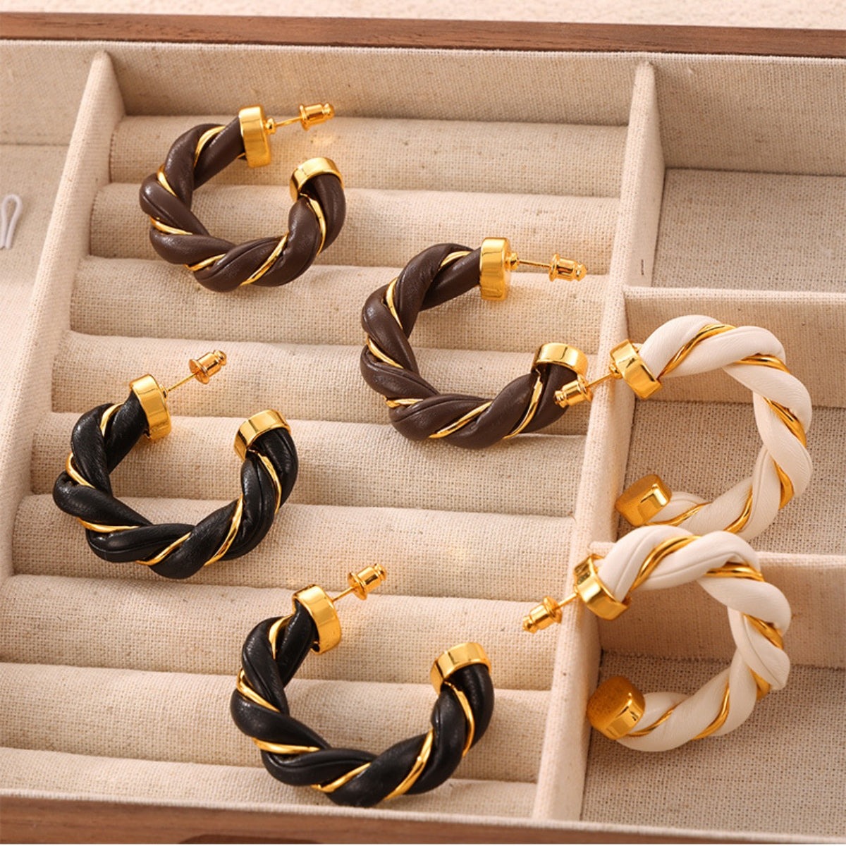 Twisted leather rope C-hoop earrings, 18K gold-plated with copper accents.