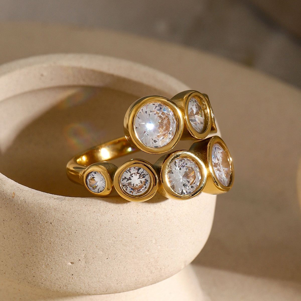 Stainless Steel Inlaid Zircon Bypass Ring with 18K gold plating and zircon stones.