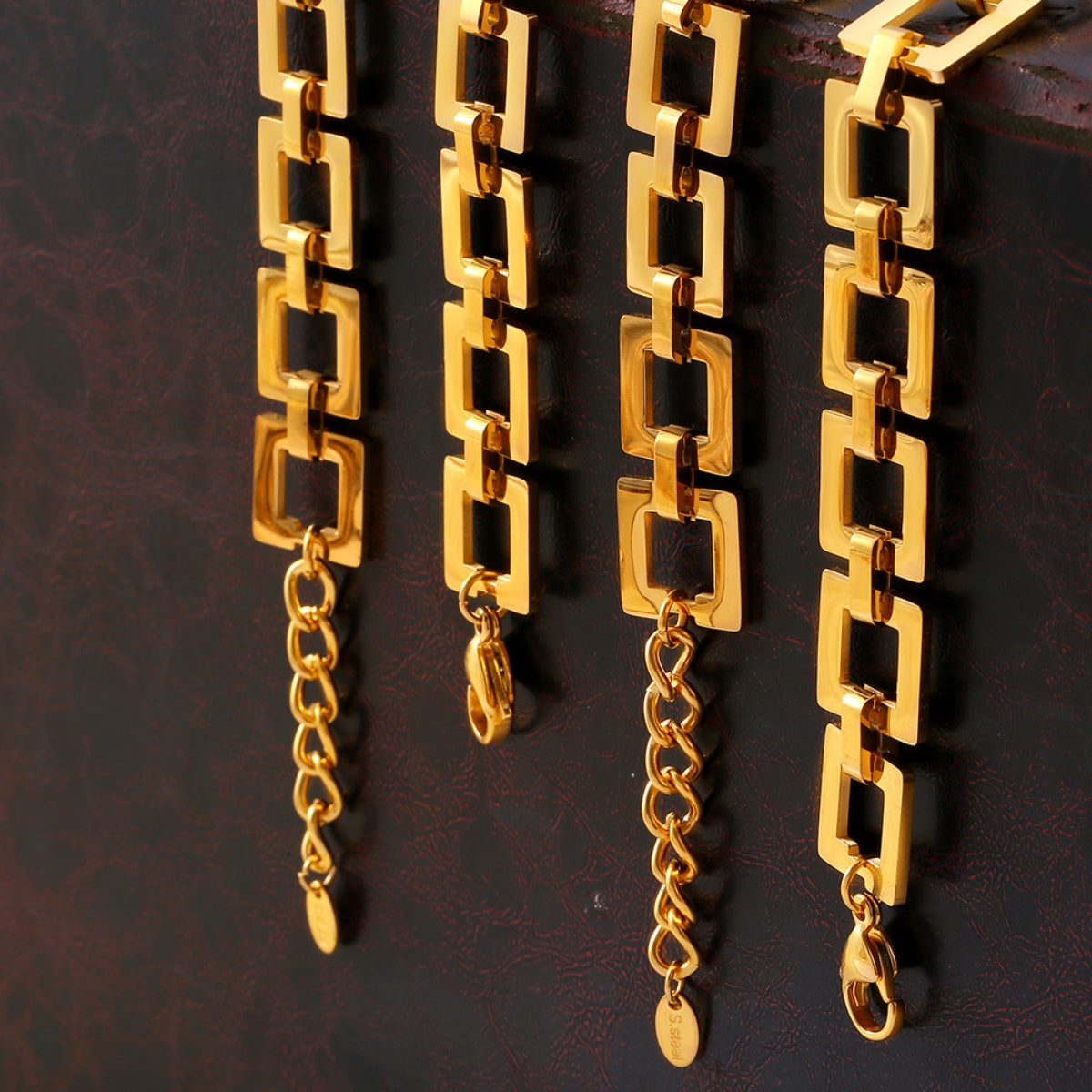 Titanium steel hollow square chain bracelet, 18K gold-plated, durable jewelry.