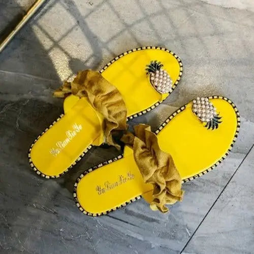 2021 Summer Beach Pineapple Flat Slippers in yellow with decorative pineapples and ruffled strap on tile floor.